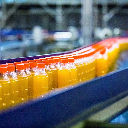 Bottles On Conveyor Belt In Factory