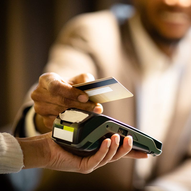 Afro Businessman Giving Credit Card To Barman