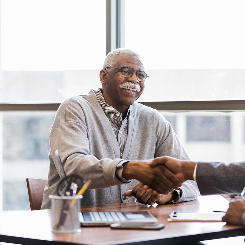 A man shakes hands with his financial advisor
