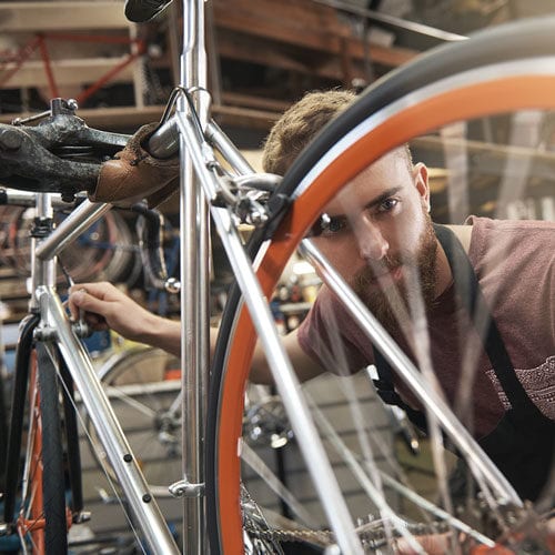 Small business owner fixing a bicycle