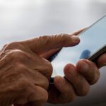Closeup Of Older Woman Hands Holding Mobile Phone