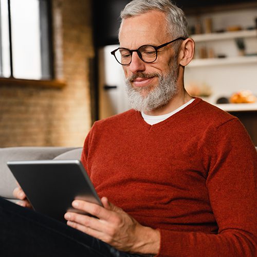 Portrait of man using personal banking on a tablet