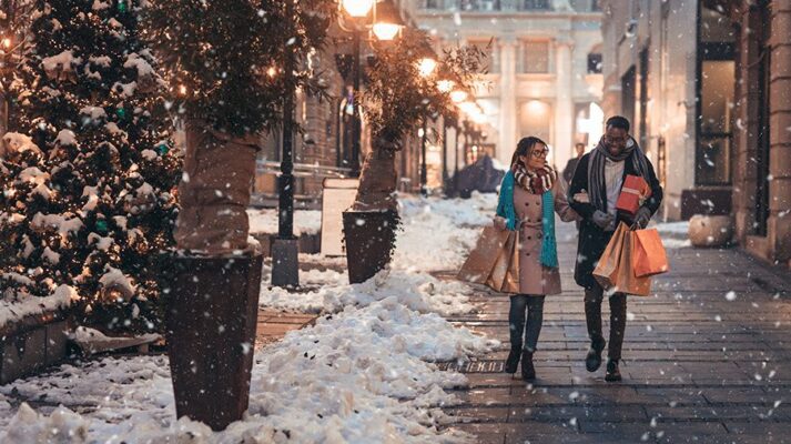 Young couple enjoy shopping for Christmas gifts.