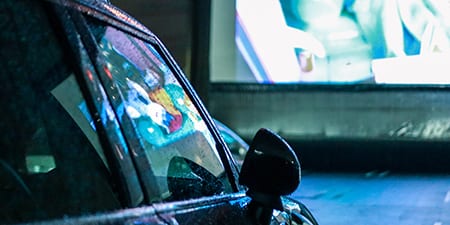people enjoying in their car at a theater