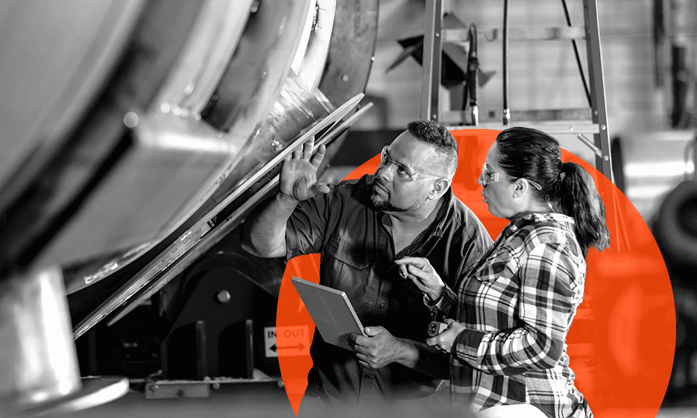Two people examine industrial equipment, with one holding a tablet and the other inspecting a metallic surface; a large orange graphic element is in the background.
