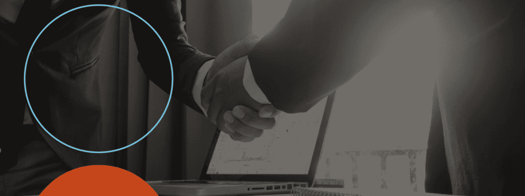 Two people in business attire shake hands in front of an open laptop, with part of the image highlighted by a blue circle and an orange semicircle in the corner.