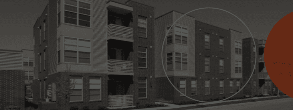 Modern brick apartment building with a blue circle highlighting a section of the facade.