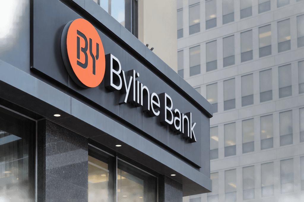 Byline Bank signage with an orange circular logo on the side of a building.